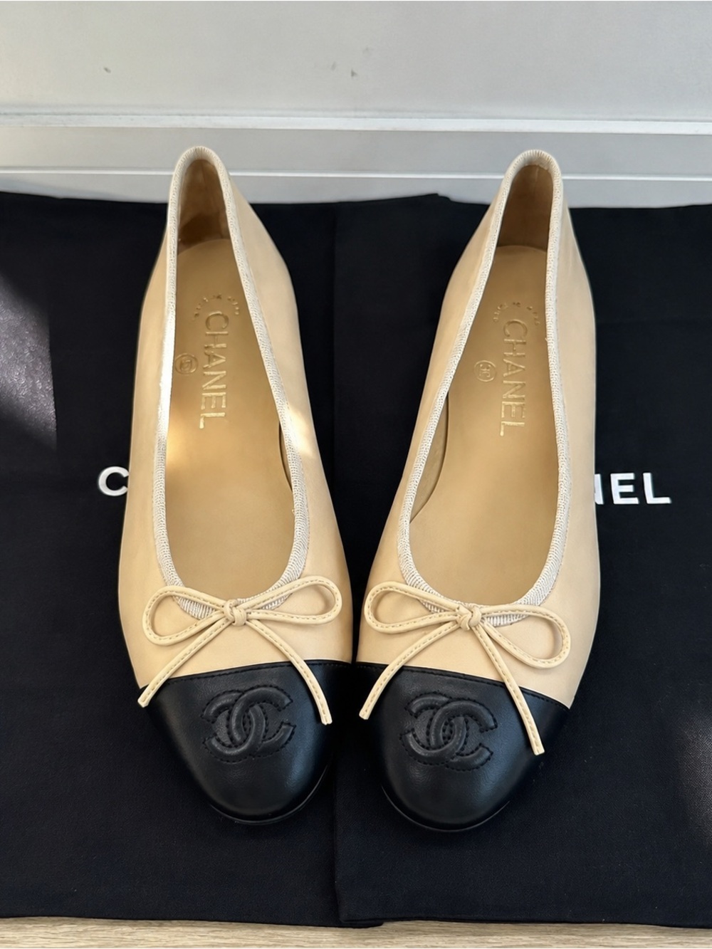 CHANEL Two-Tone Beige and Black Cap-Toe Ballet Flats